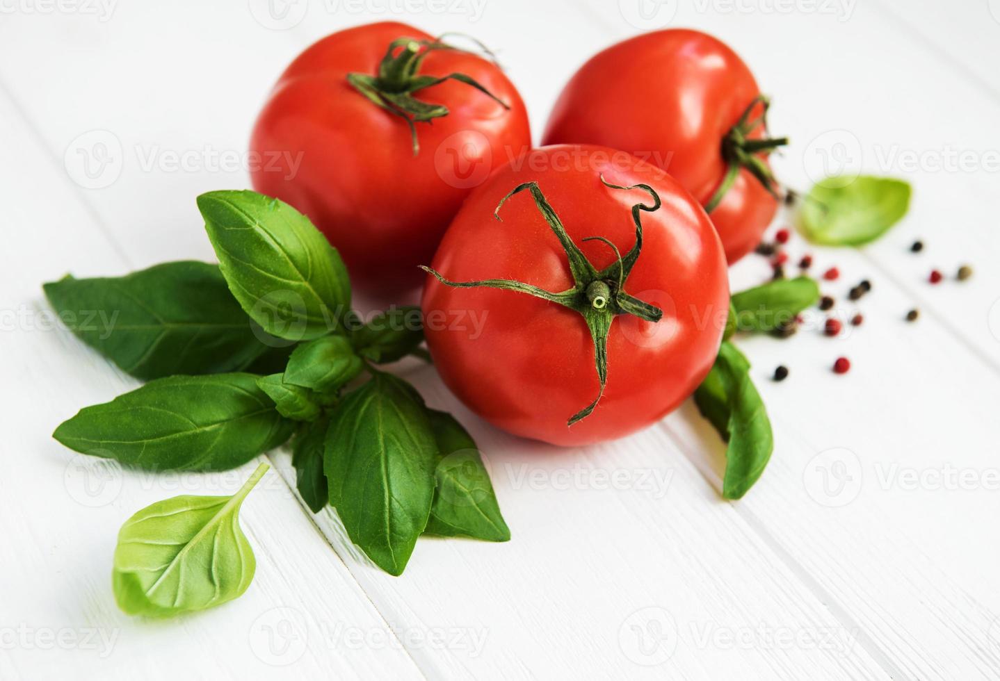 Fresh tomatoes with green basil photo