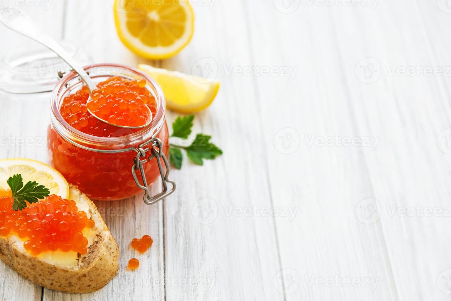 Glass jar of red caviar photo