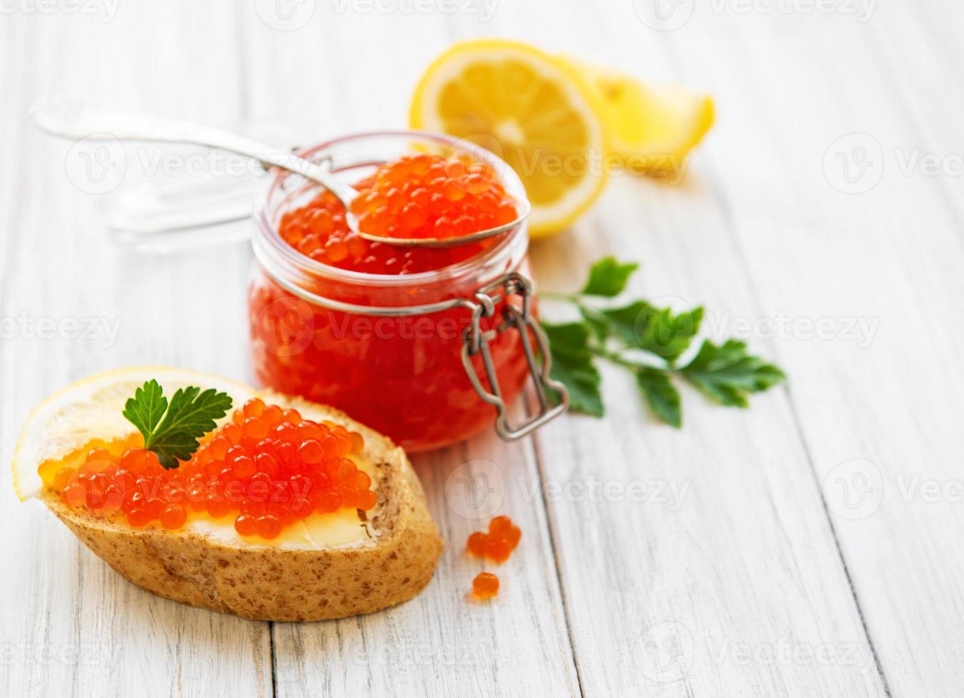 Glass jar of red caviar photo