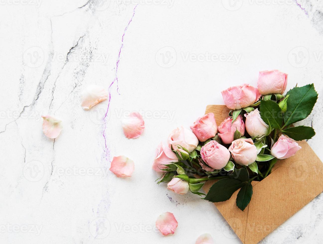 Envelope and pink roses photo