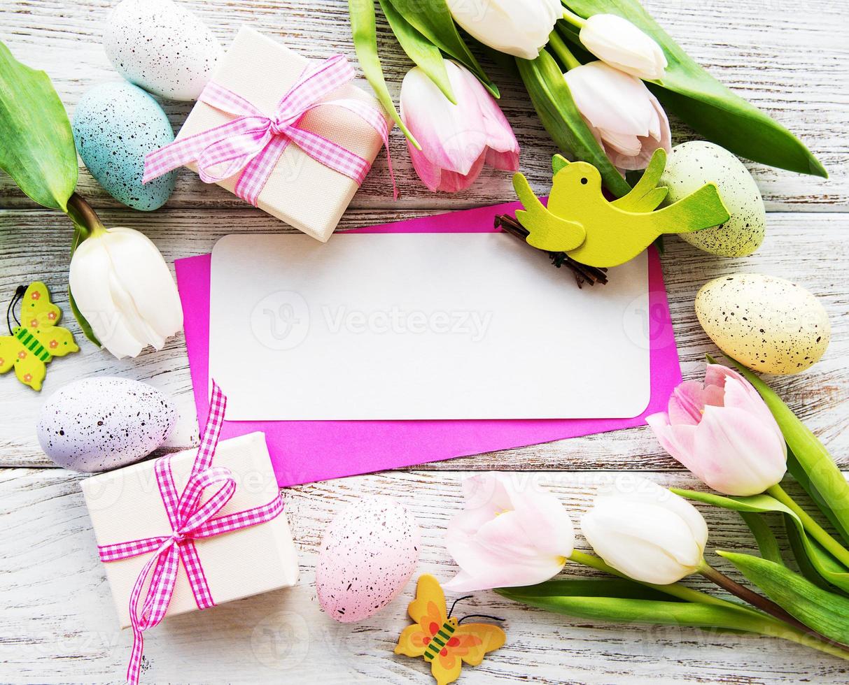 Gift boxes, easter eggs and tulips bouquet photo