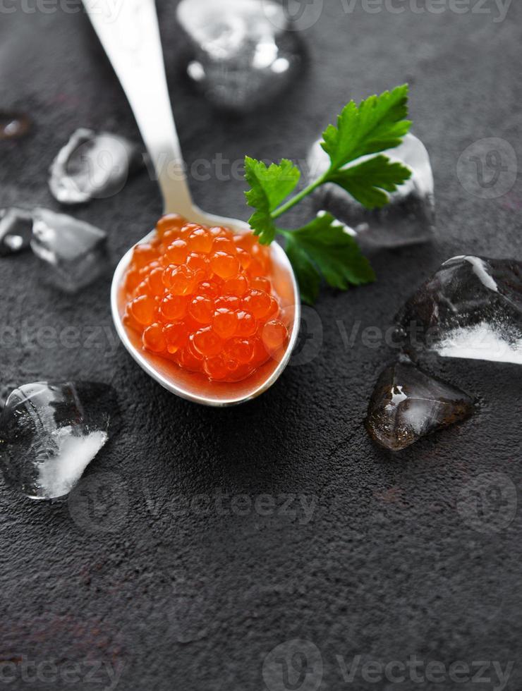 Spoon with delicious red caviars photo