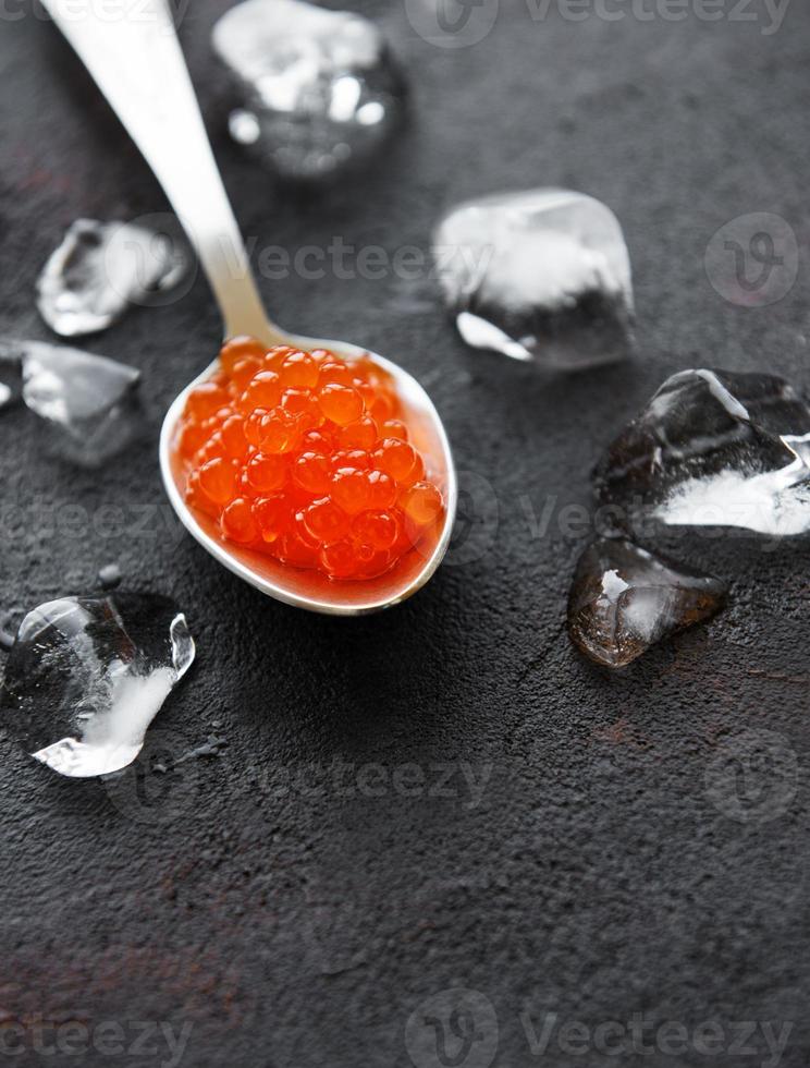 Spoon with delicious red caviars photo
