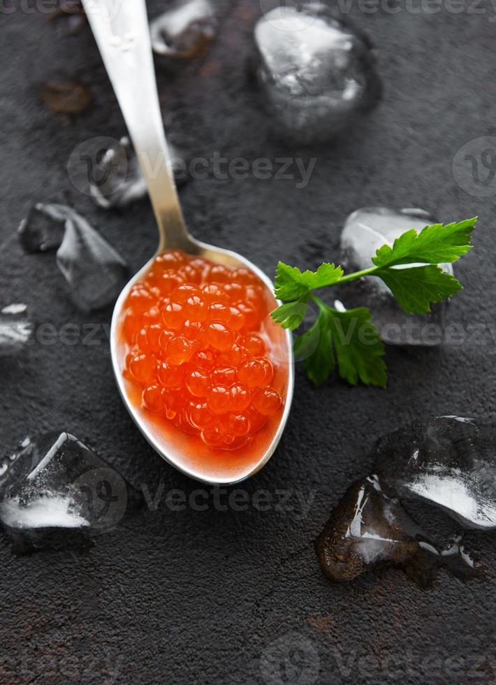 Spoon with delicious red caviars photo