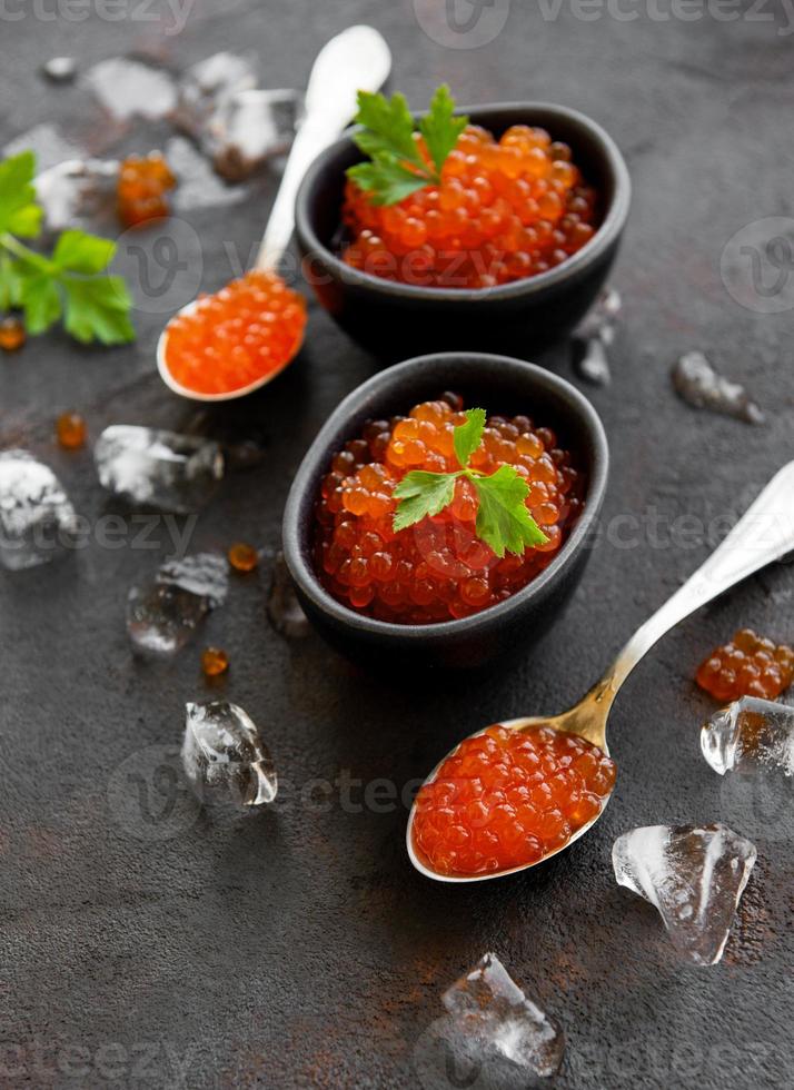 Red caviar on a black background photo