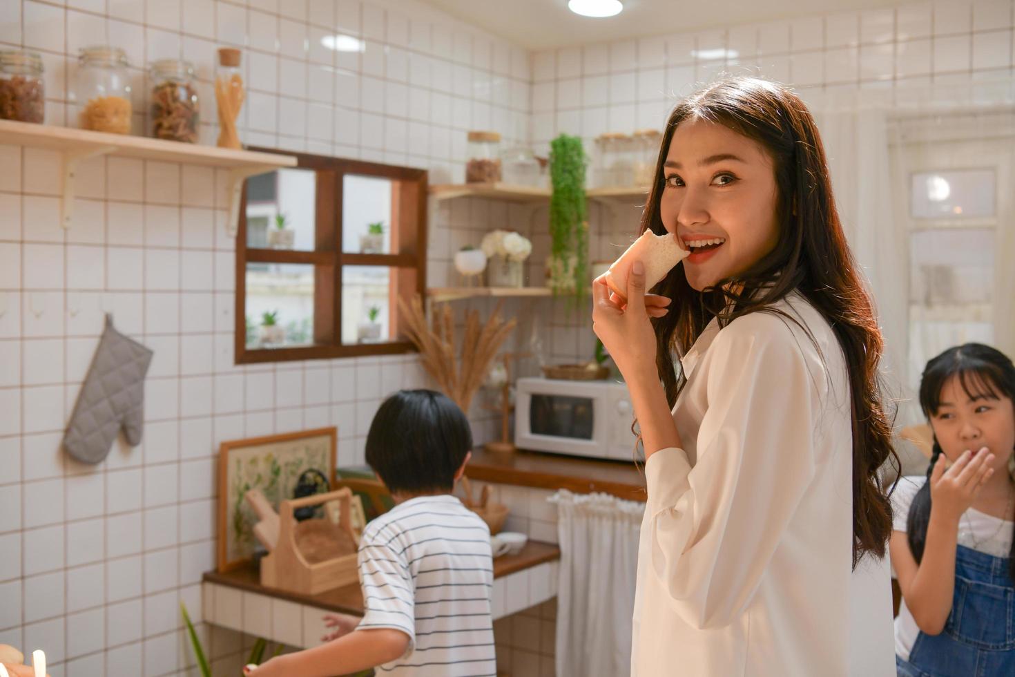 Family happy moments when children Helping mom cook food in the kitchen. photo