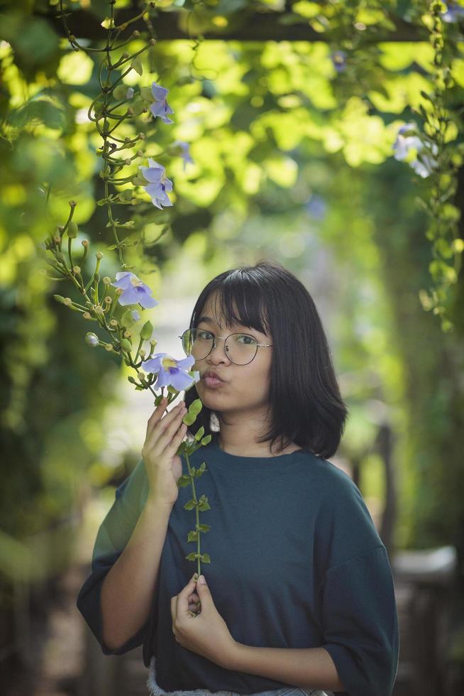 asian teenager playing in green natural park photo