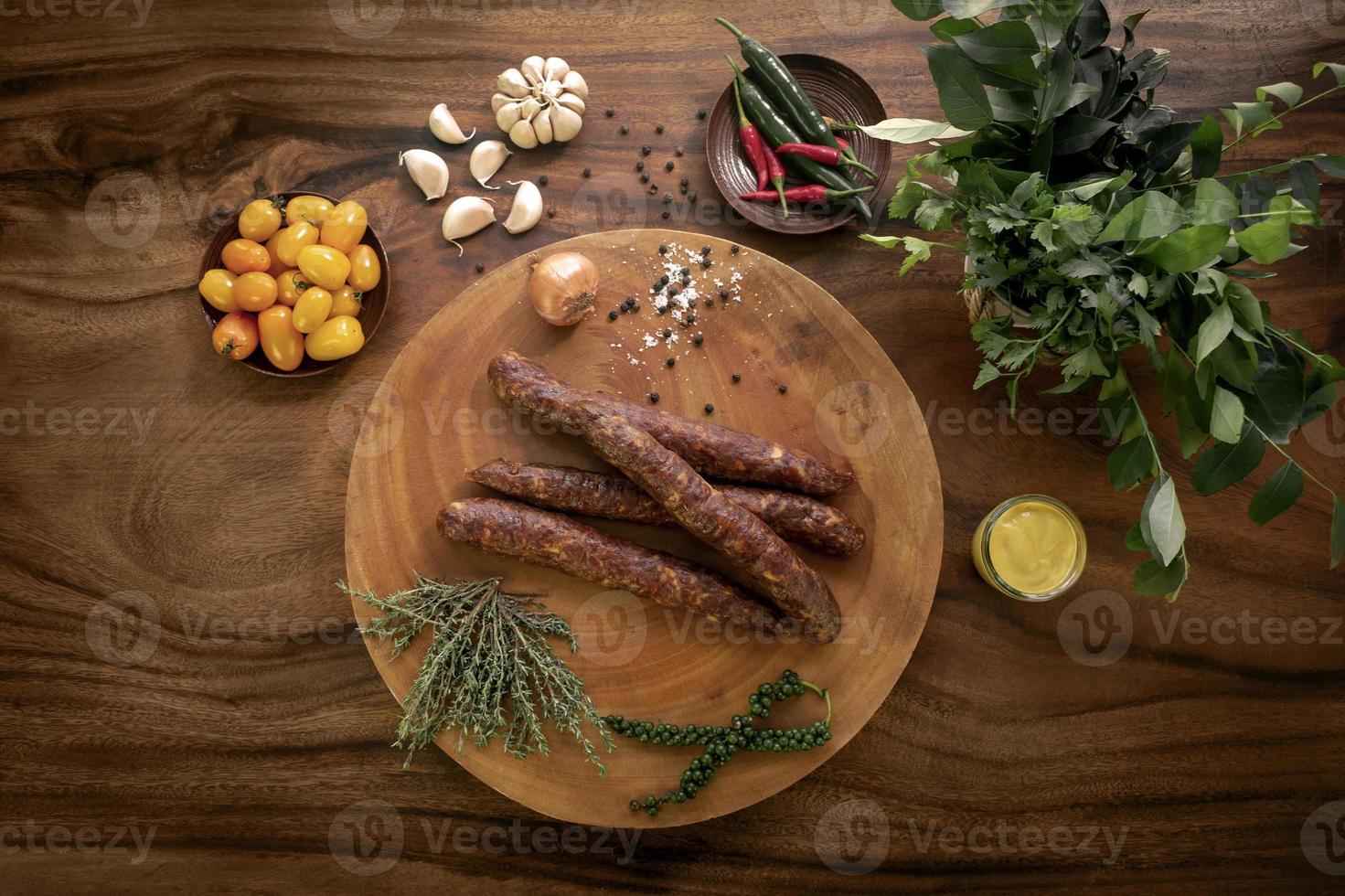 spanish chorizo sausages on rustic wood table with natural ingredients photo