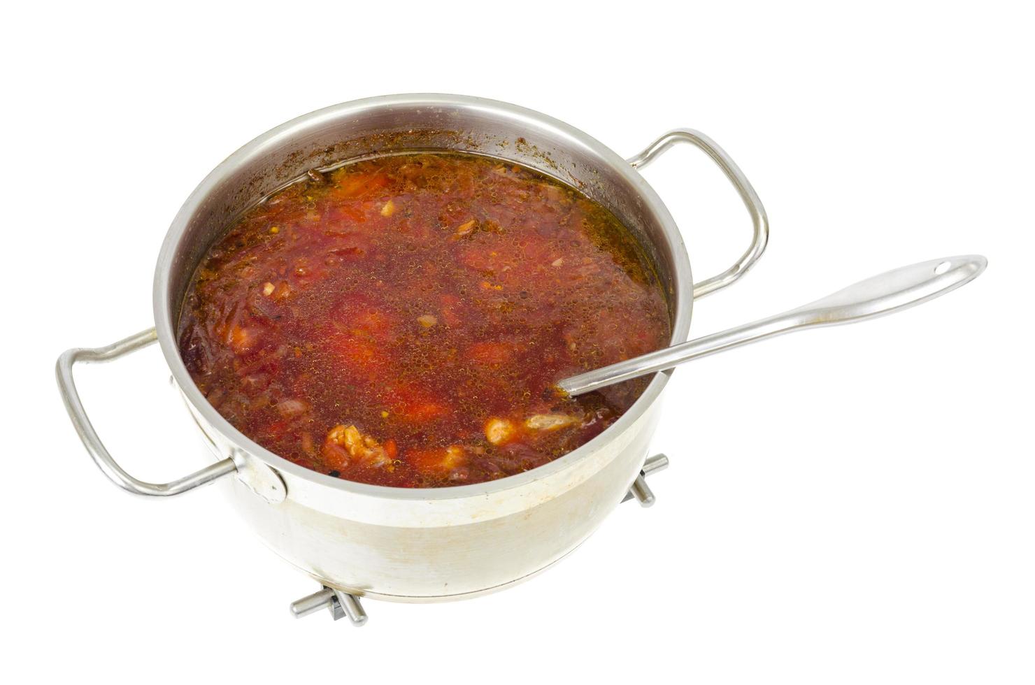 Saucepan with vegetable beetroot soup on white background. photo