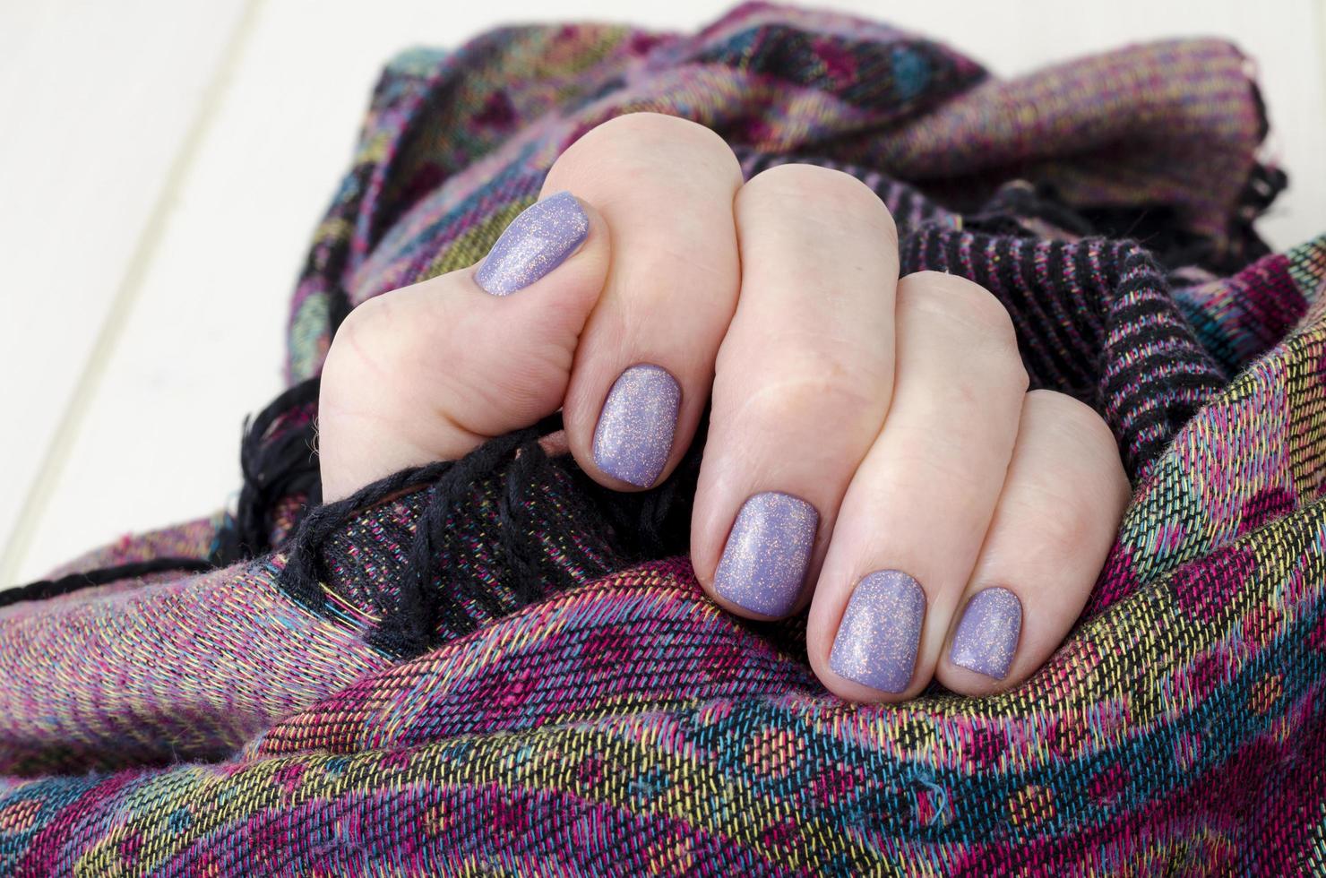 Hand of an adult woman with painted nails, manicure, nail polish photo