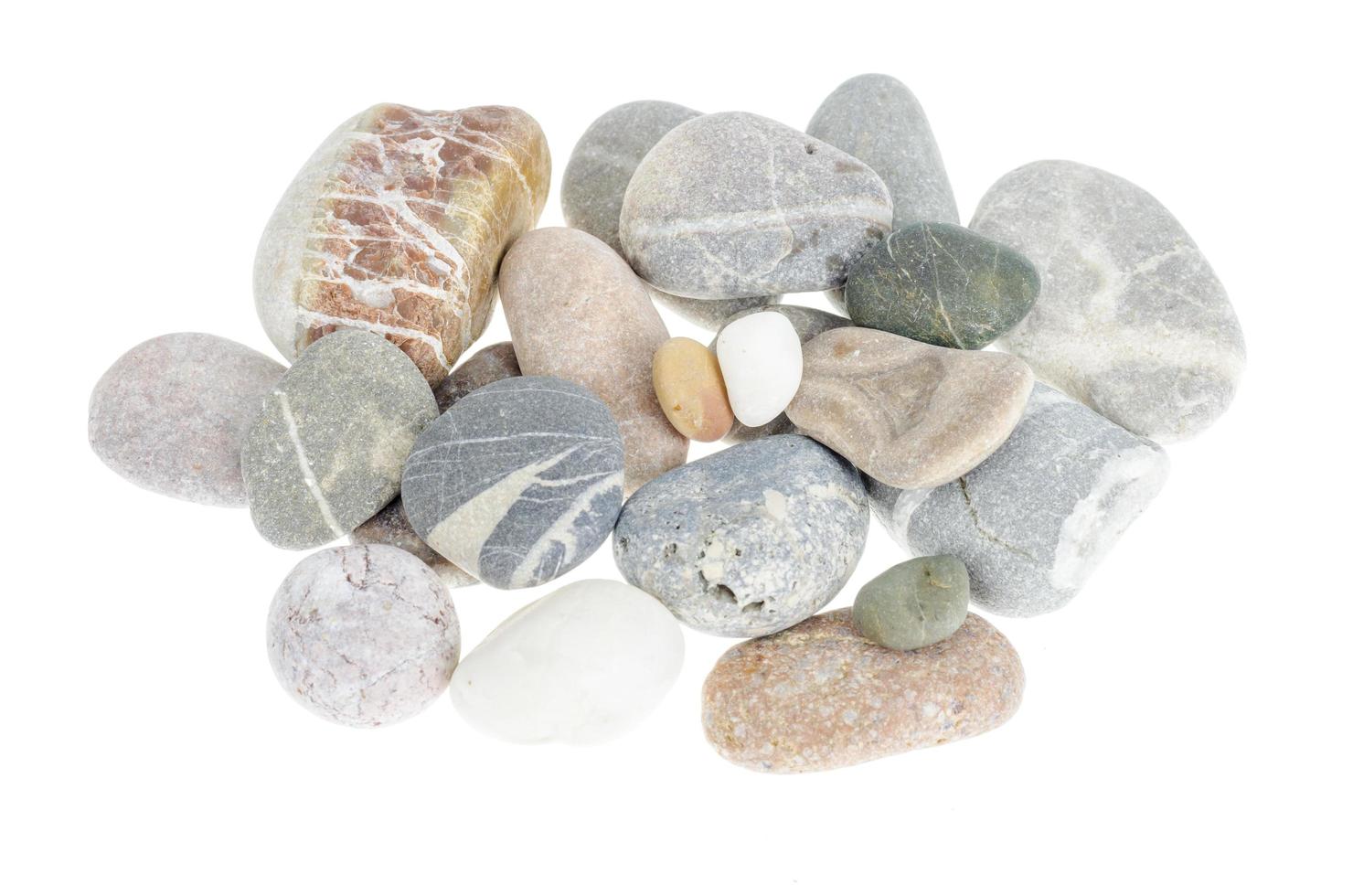 Pile of gray sea smooth pebbles isolated on white background. photo