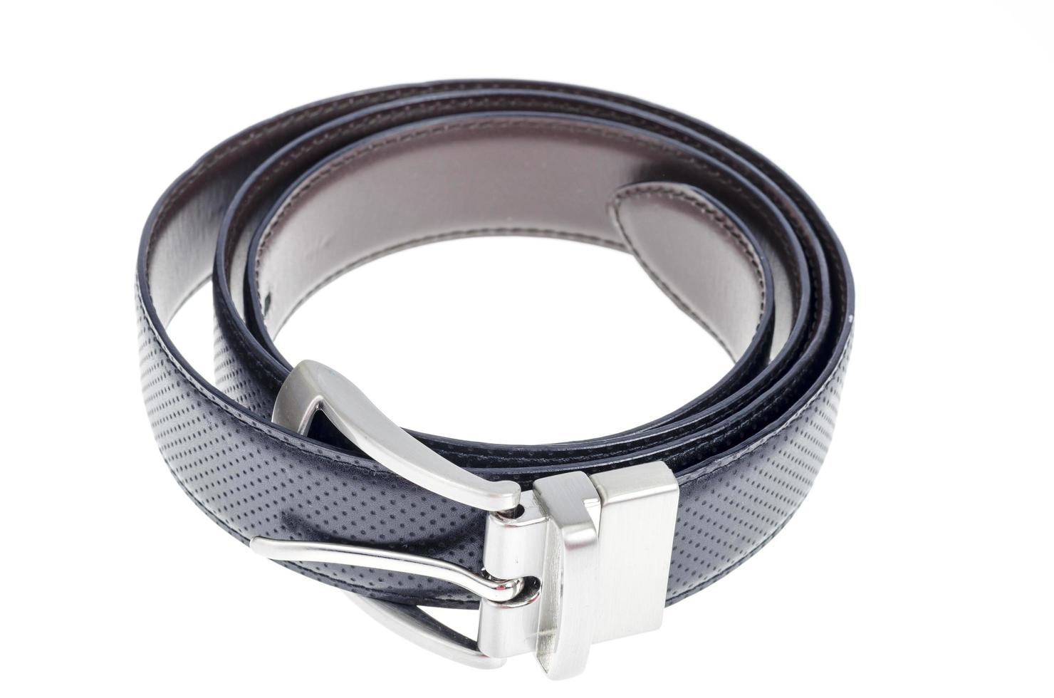 Black leather twisted belt isolated on white background. photo