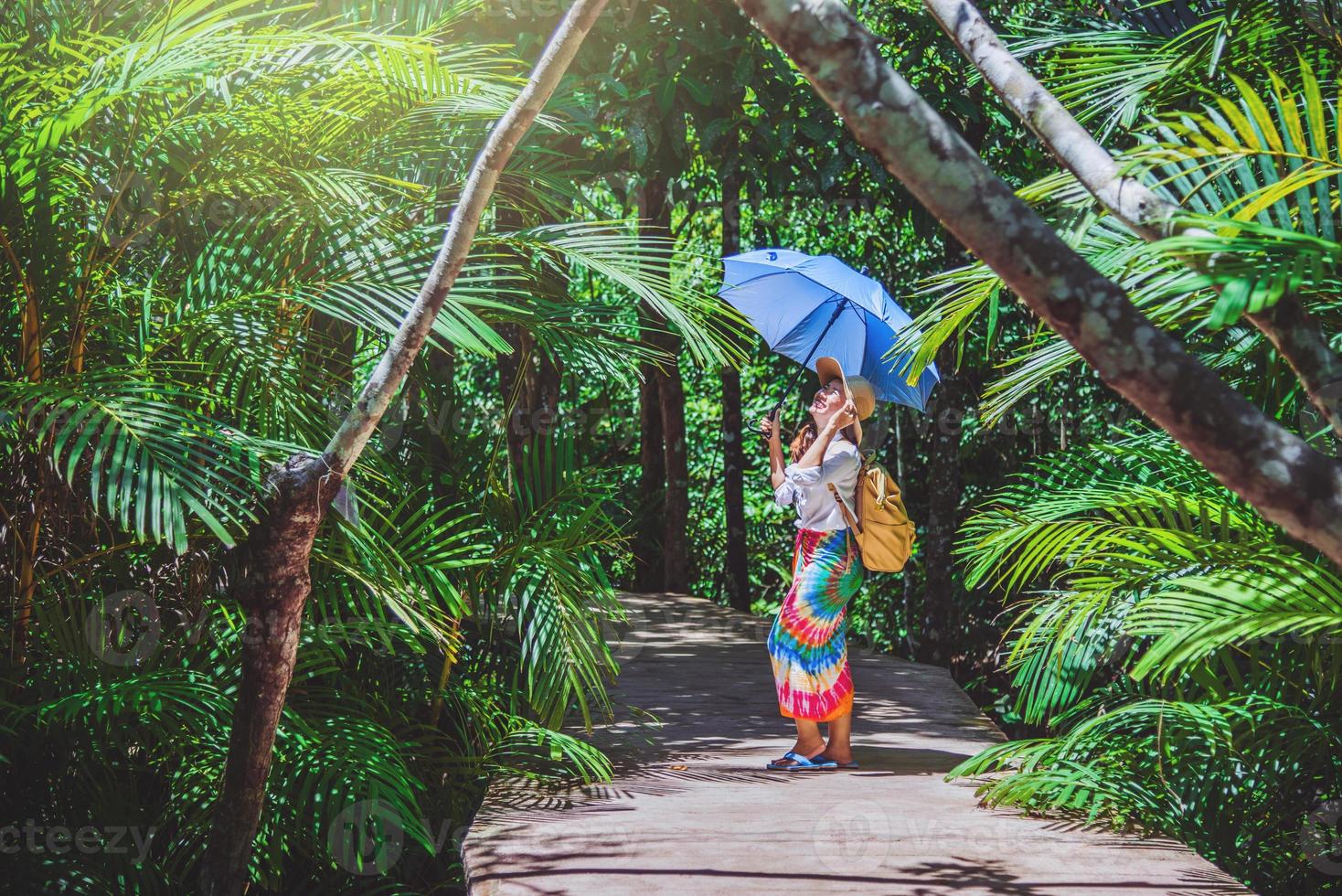 Asian women travel relax travel nature in the holiday. Nature Study in the forest. Girl happy walking smiling and enjoying travel through the mangrove forest. tha pom-klong-song-nam at krabi. summer photo