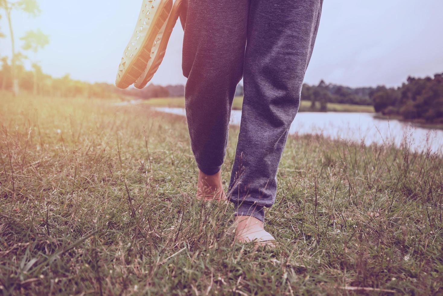 Asian women relax in the holiday. Walking foot on the meadow photo