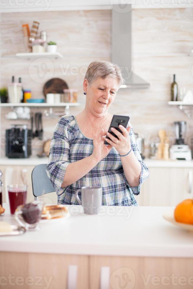 Elderly woman reading message photo