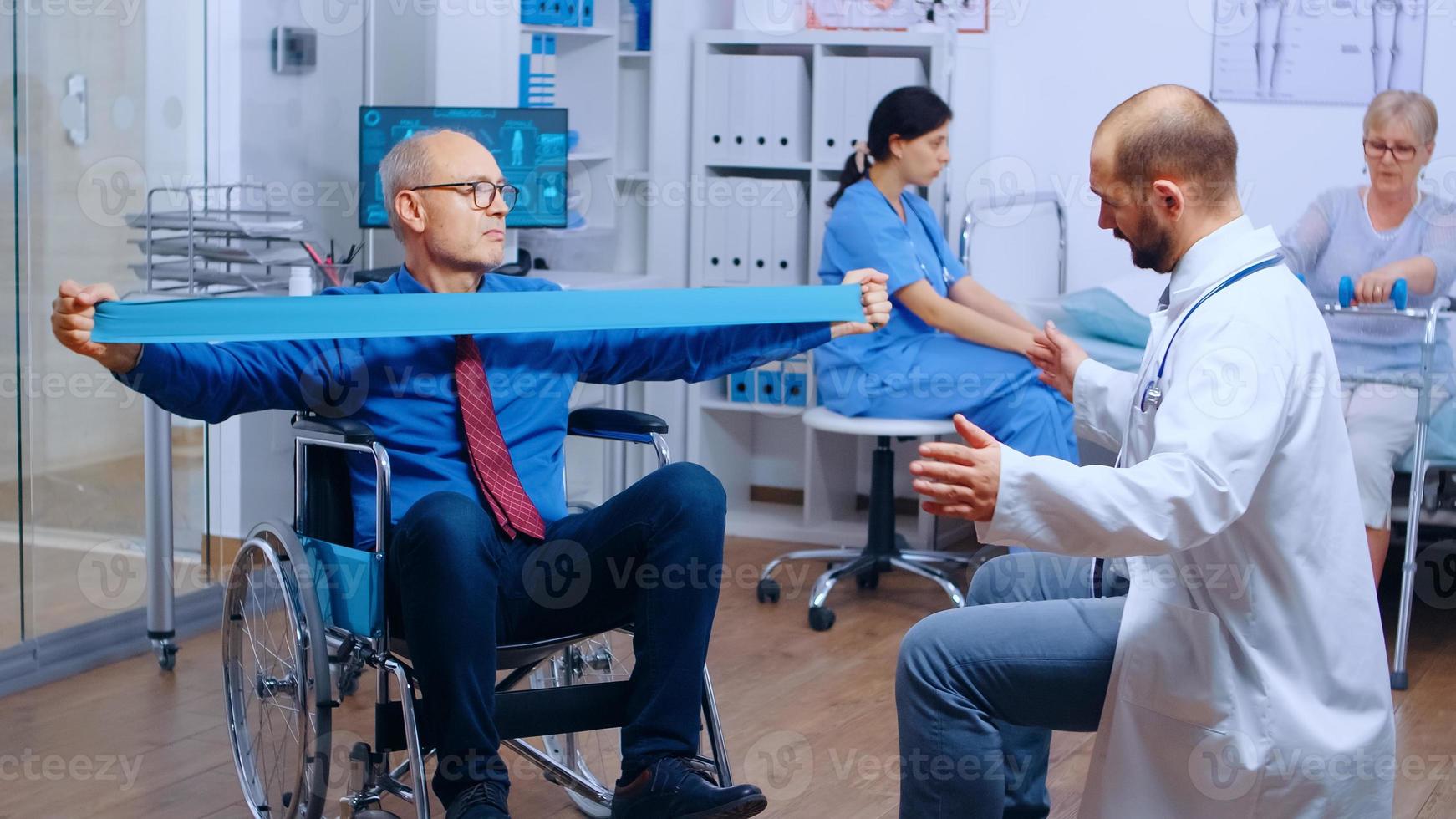 Handicapped injured man training with elastic band photo