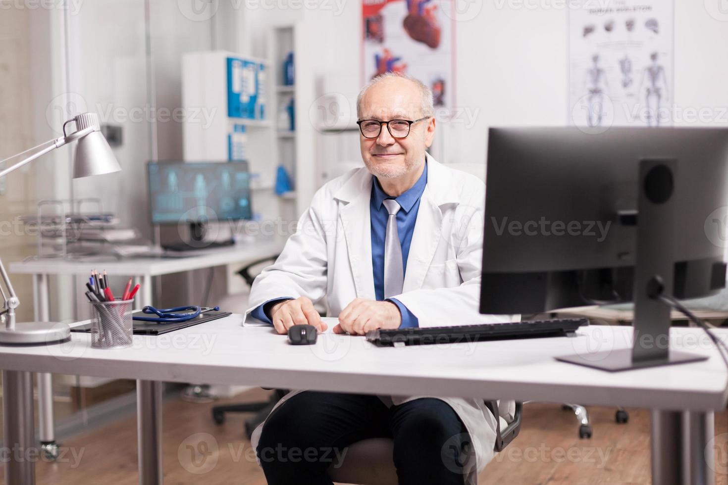 Positive elderly aged doctor photo