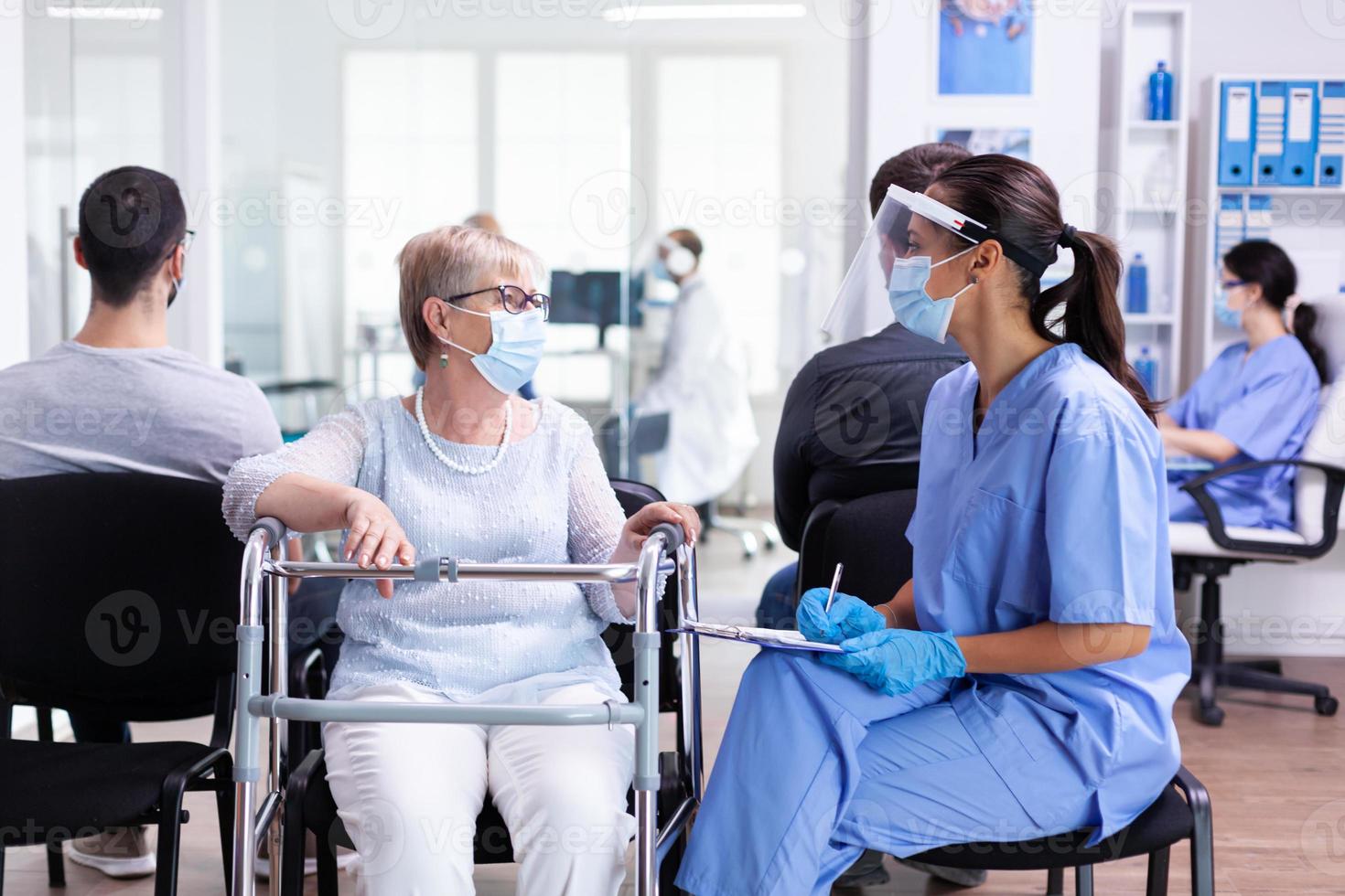 Handicapped woman discussing with medical staff photo