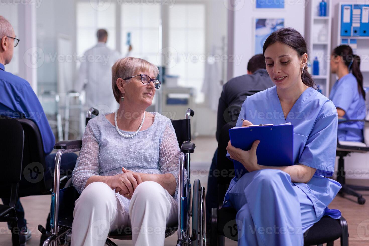 Assistant taking notes on clipboard about patient madical problems photo