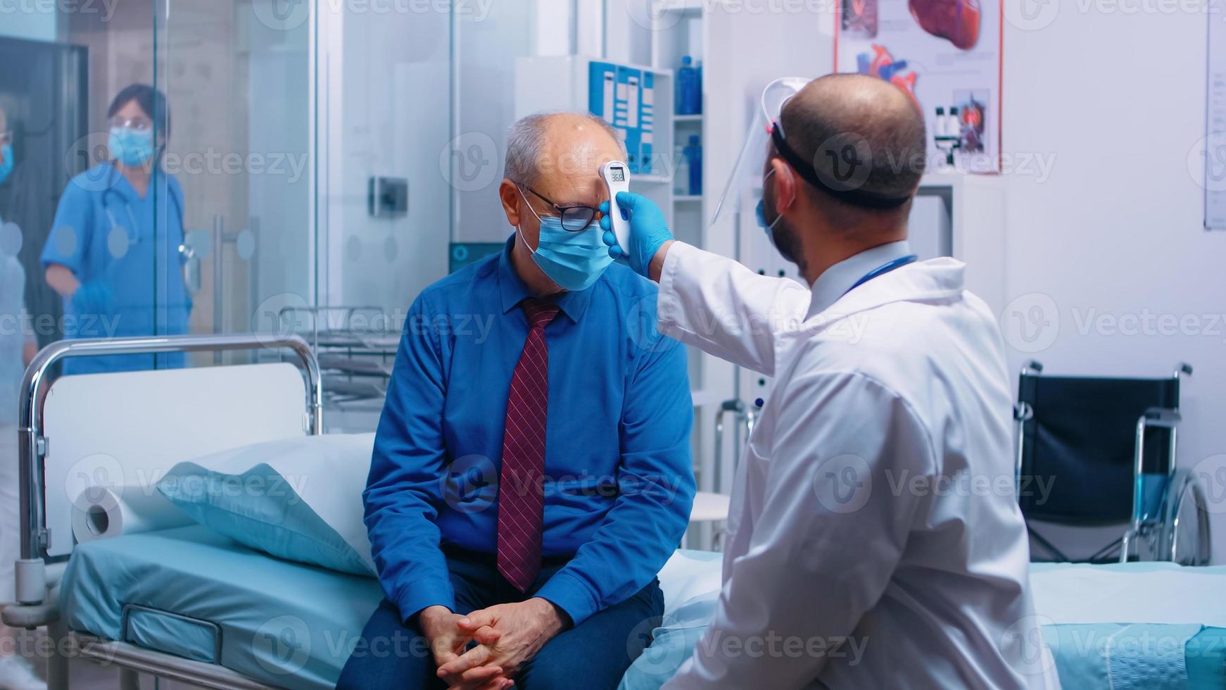 doctor usando termómetro infrarrojo foto