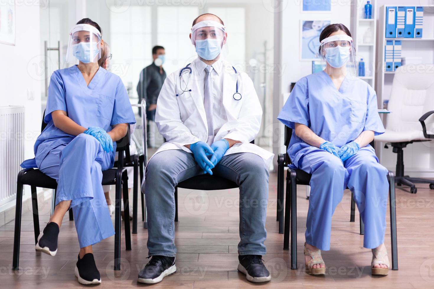 Group of medical staff sitting in hospital photo