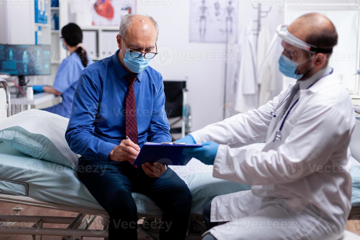 Senior patient signing document photo