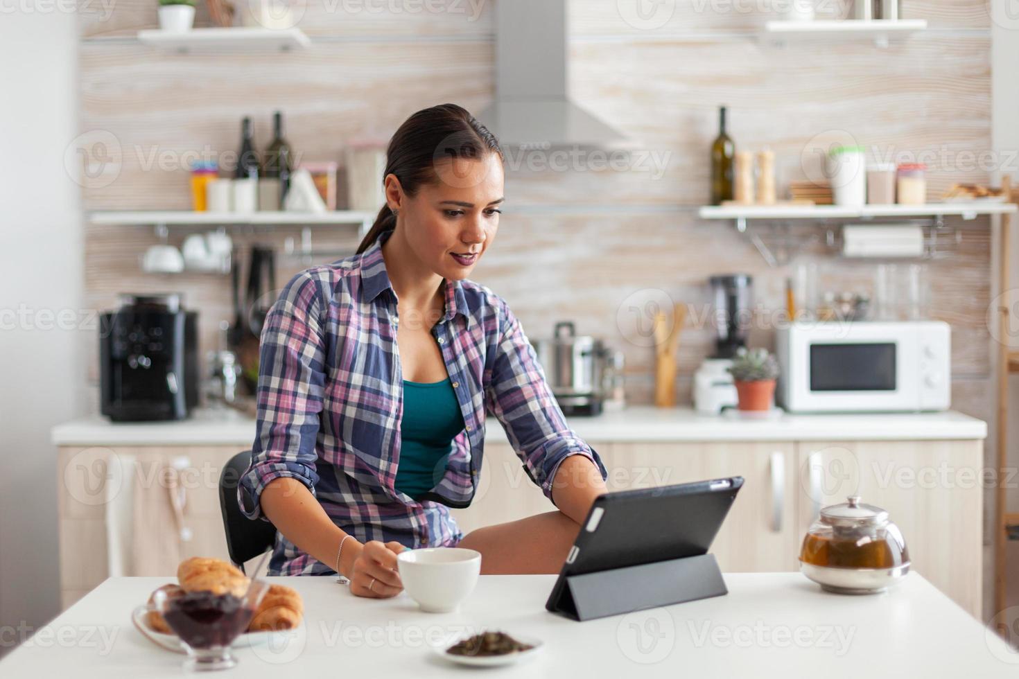 Woman reading news on tablet photo