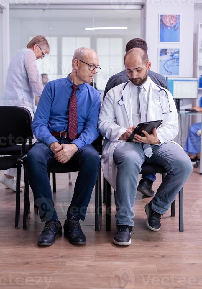 Specialist doctor talking with old man explaining test resulat photo