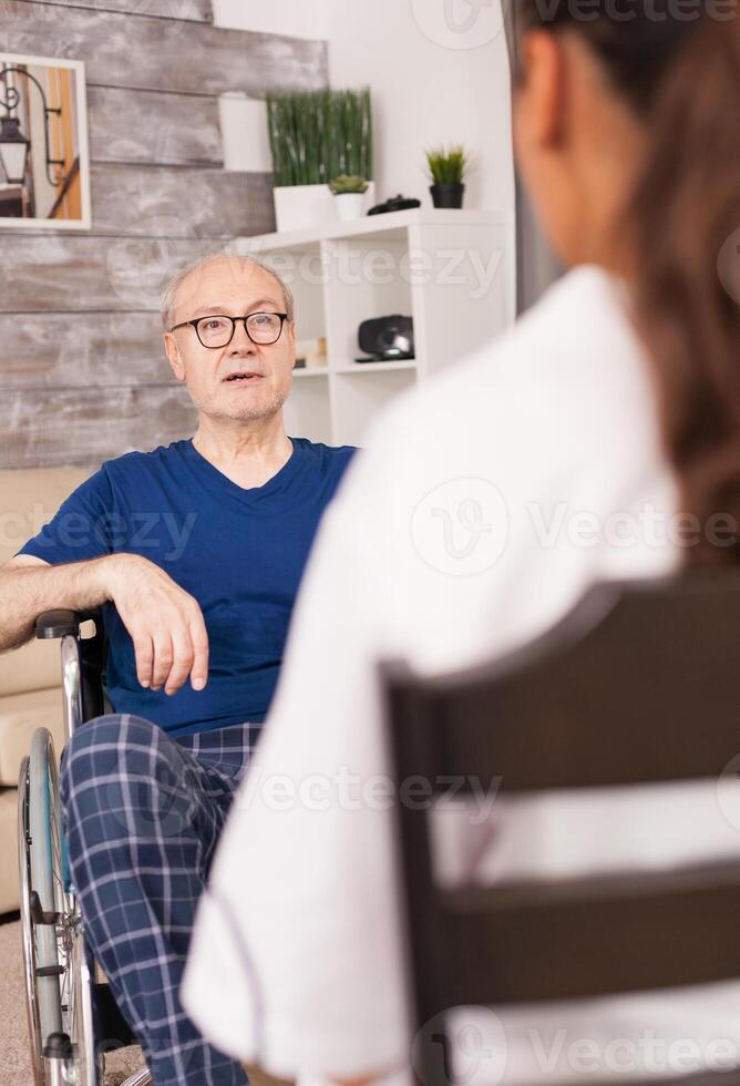 Old man talking with nurse photo