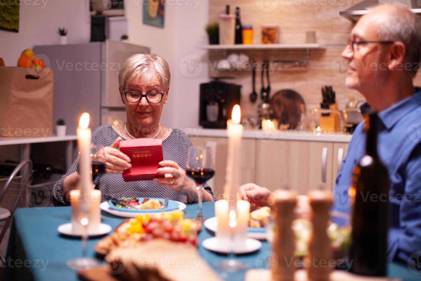 Retired woman holding gift box photo