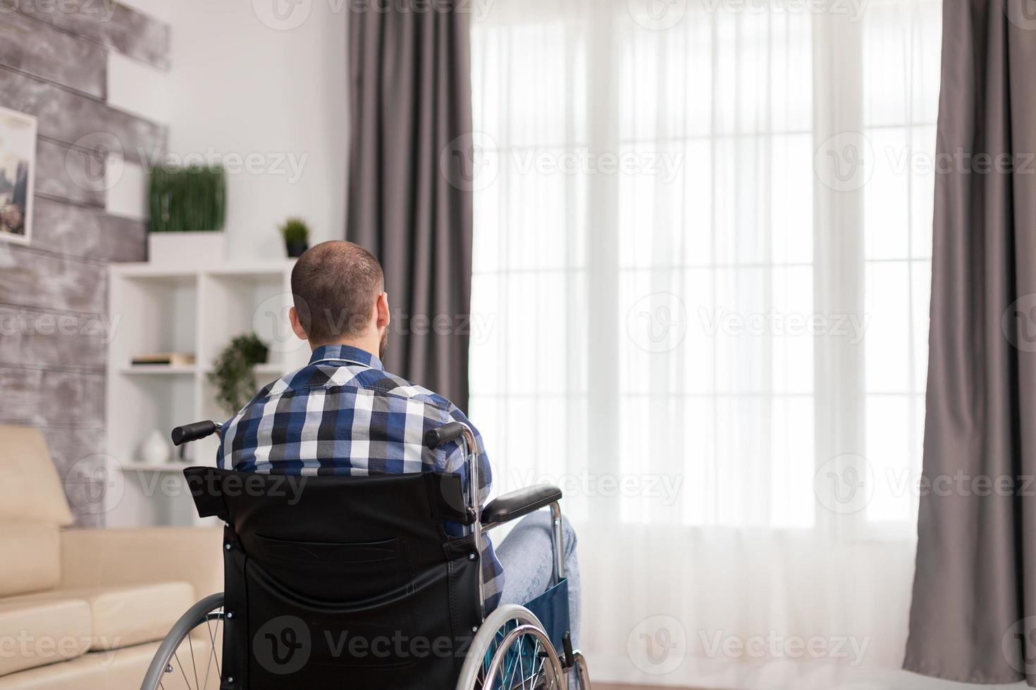 Unhappy man in wheelchair photo
