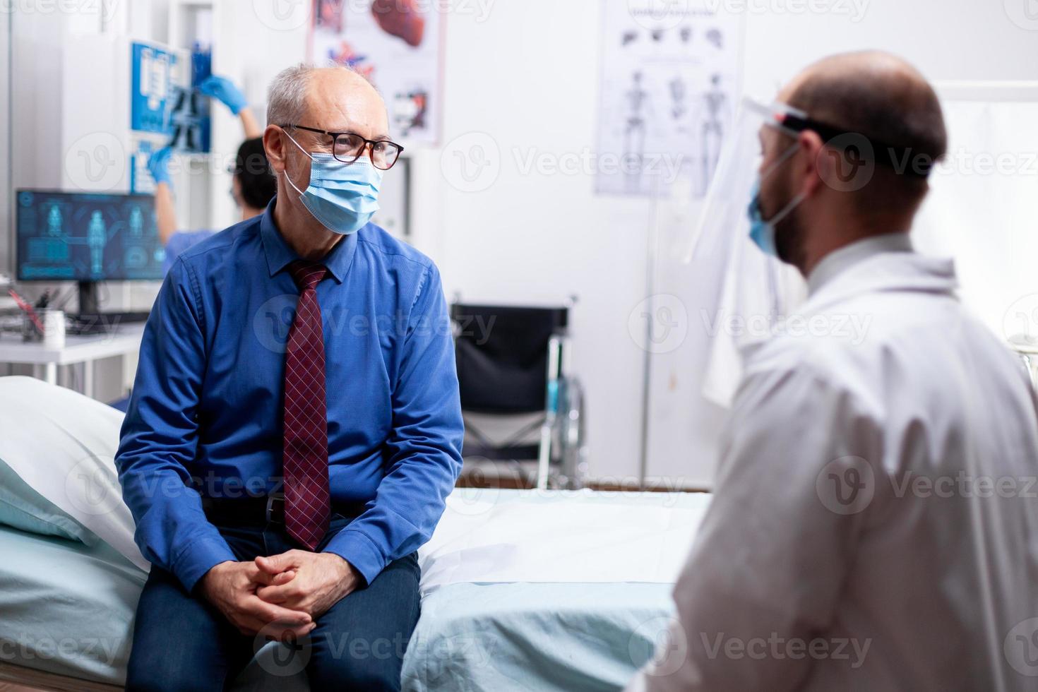 Sick old man listening doctor photo