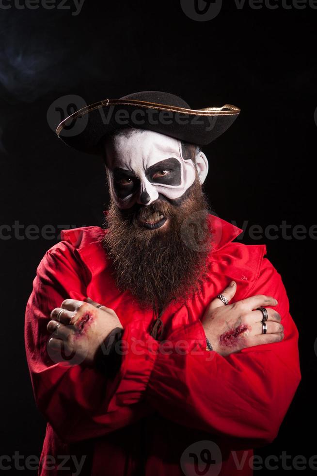 Bearded man in pirate outfit wearing spooky makeup photo