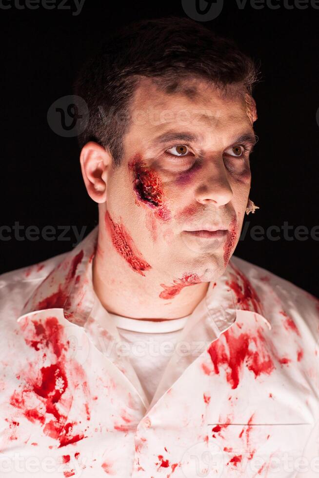 Close up of spooky zombie covered in blood photo