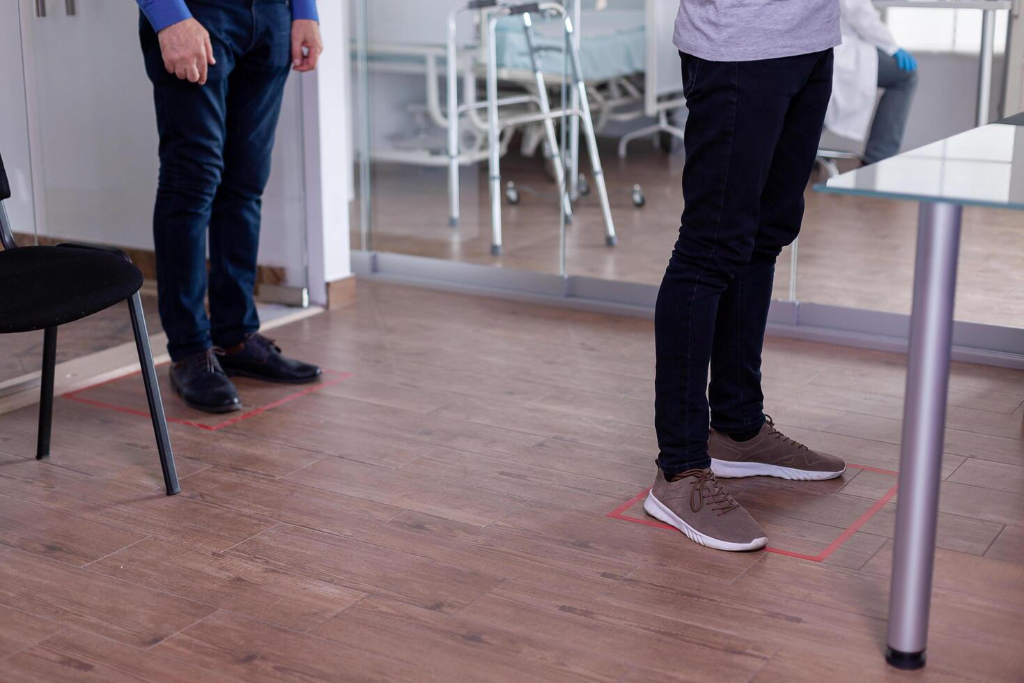 Close up of people standing in waiting room on floor signs photo