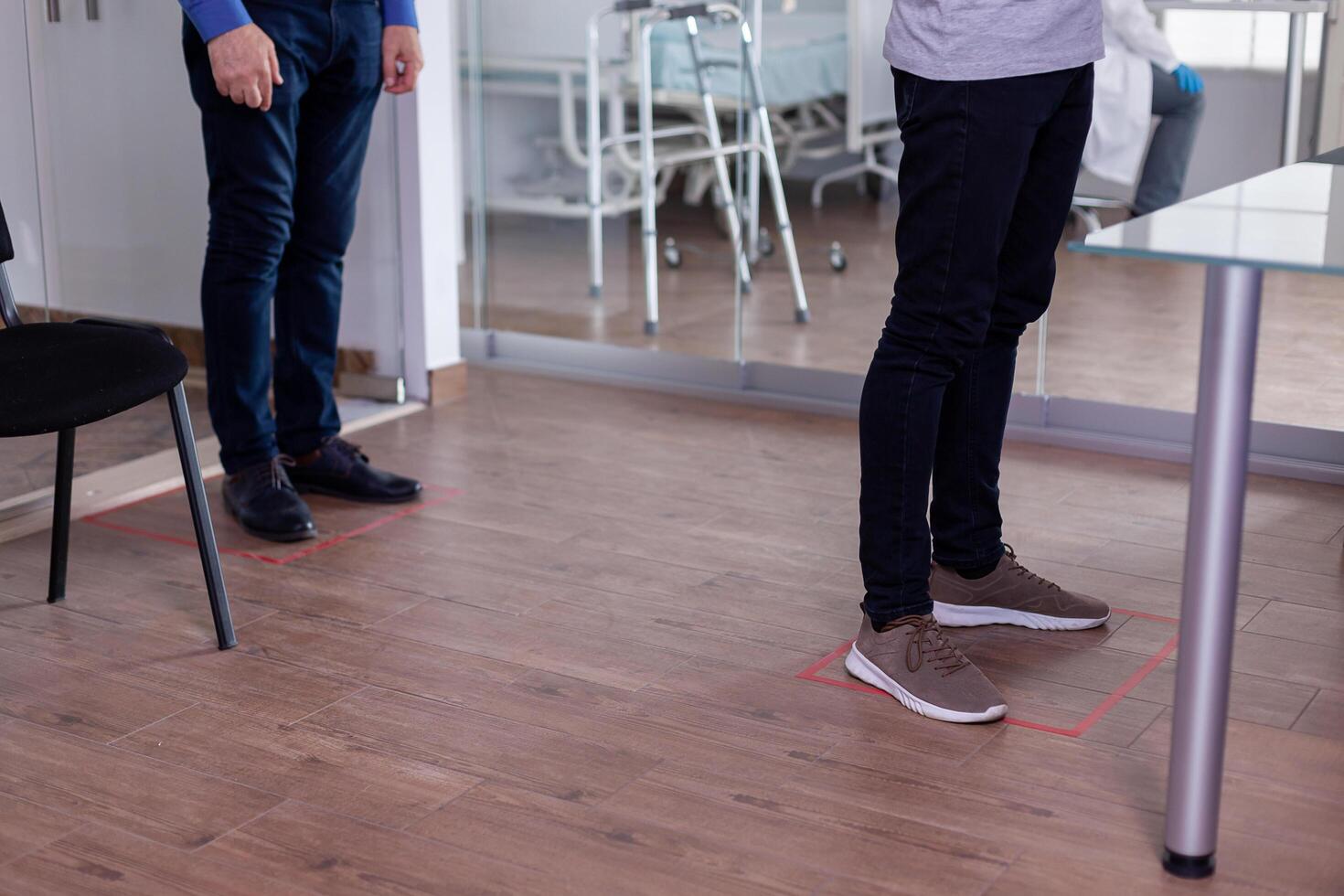 Close up of people standing in waiting room on floor signs photo