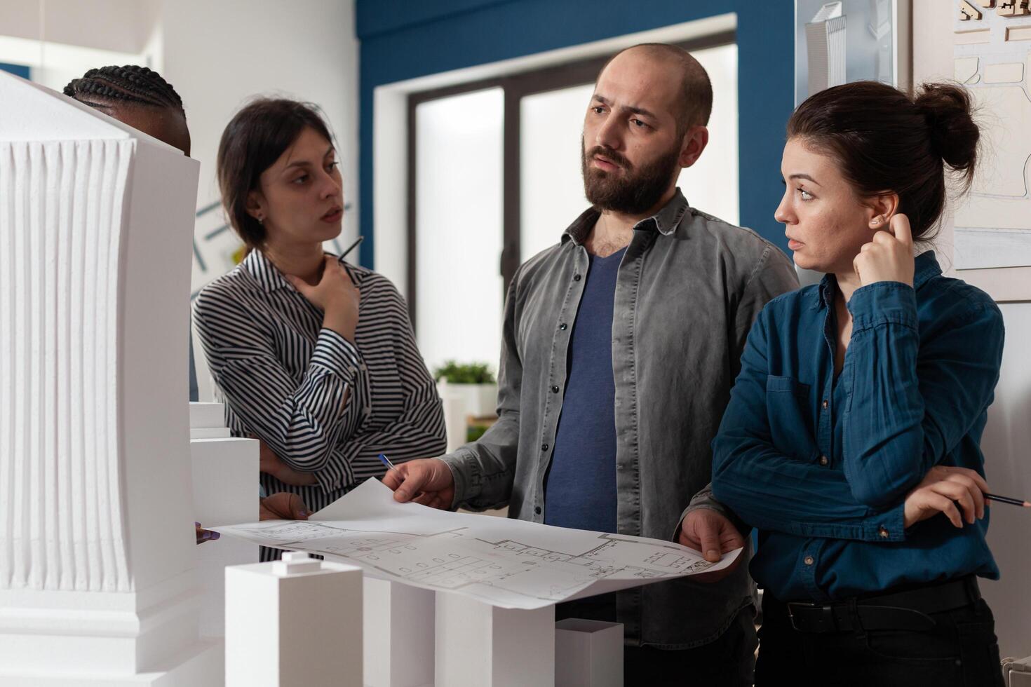 Architectural diverse work group talking about project photo
