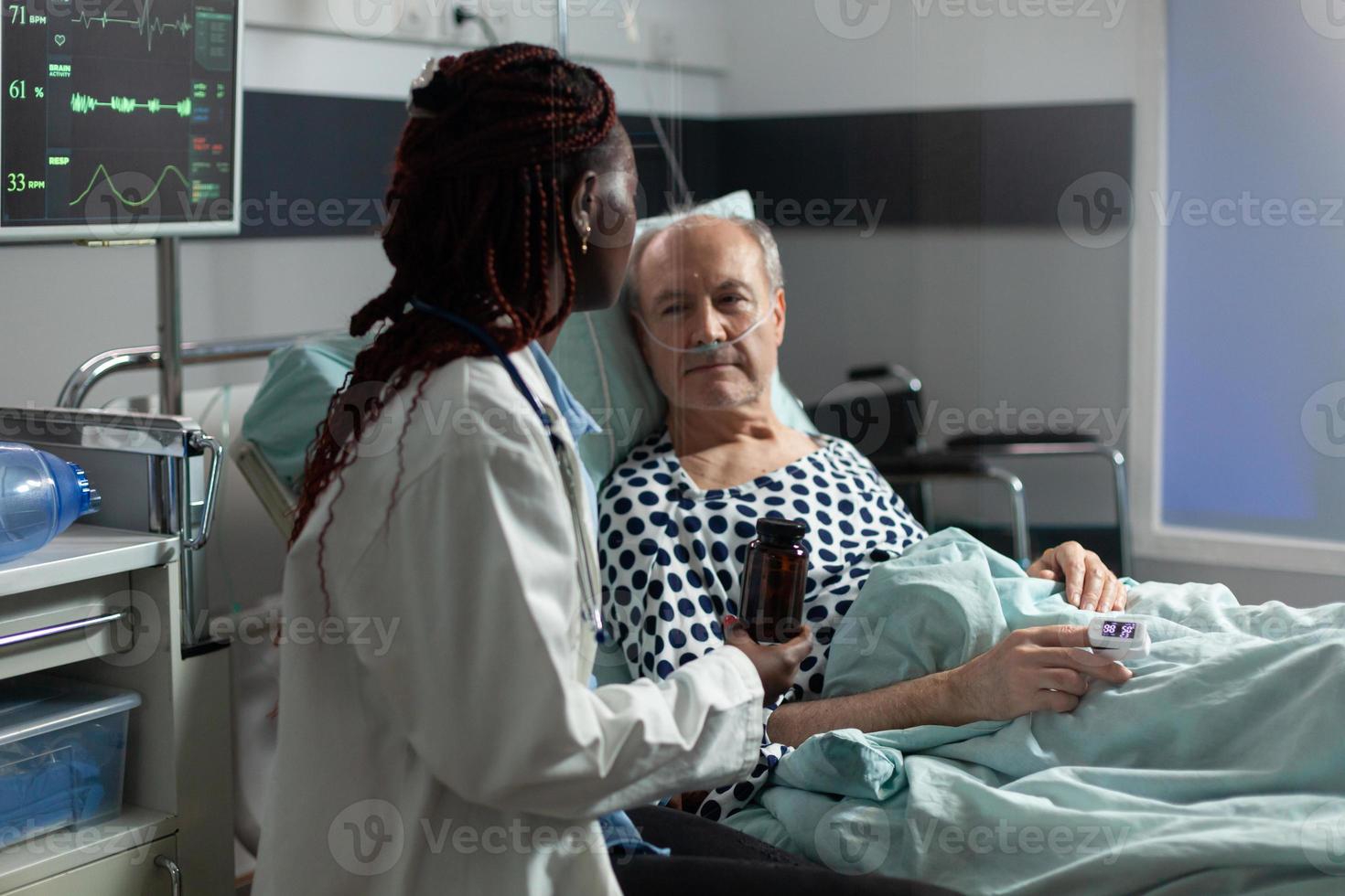 Senior man breathing with help from oxygen tube photo