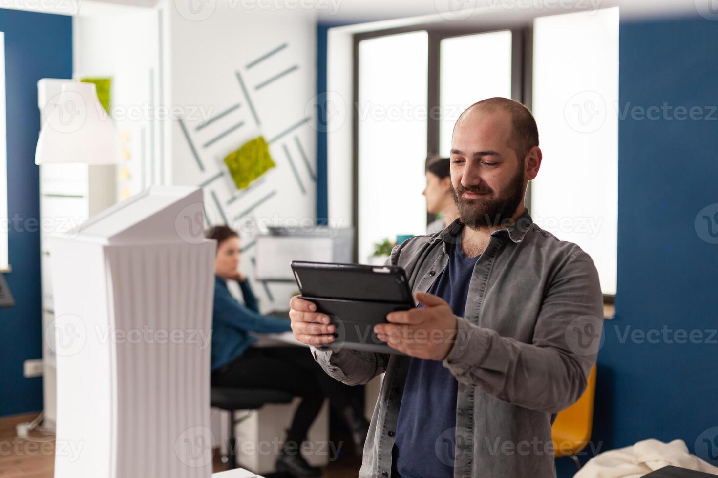 Work manager man looking on tablet at architecture office photo