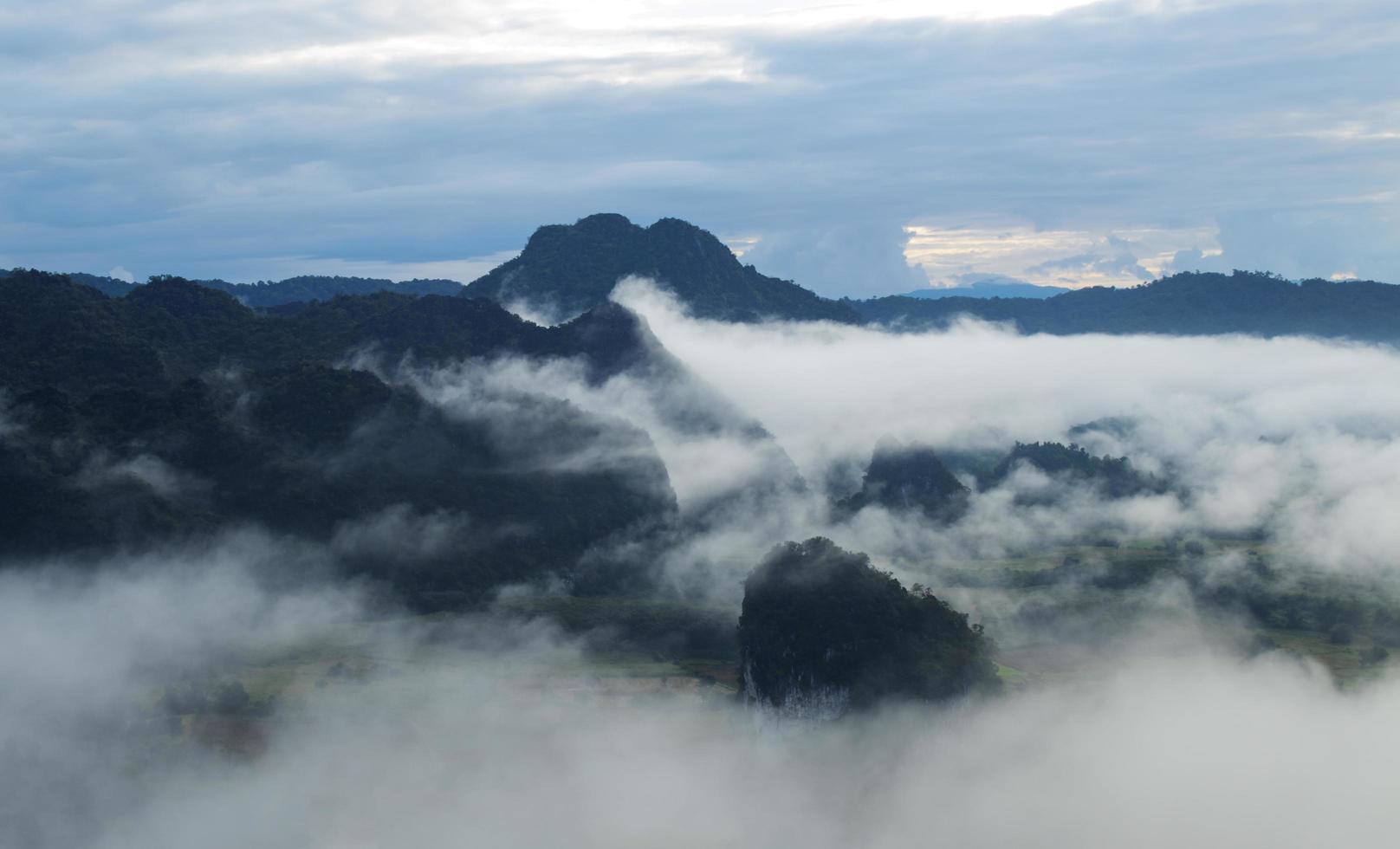 Mountains covered with white mist in winter at Phu Langka, Thailand photo