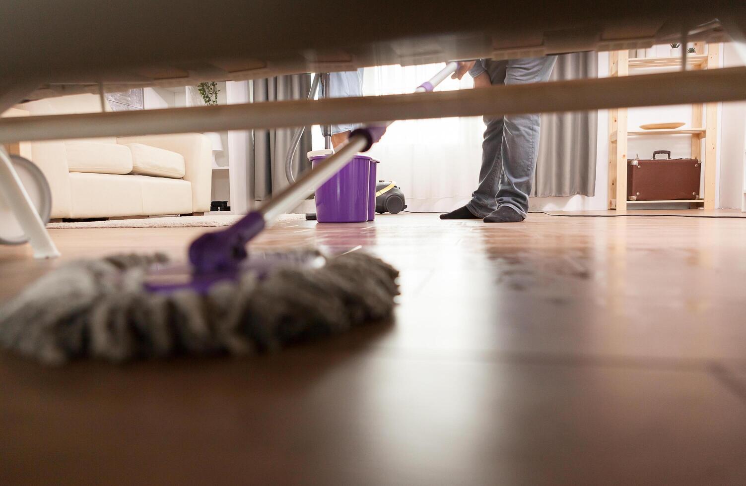 Cleaning dust under sofa 4623716 Stock Photo at Vecteezy