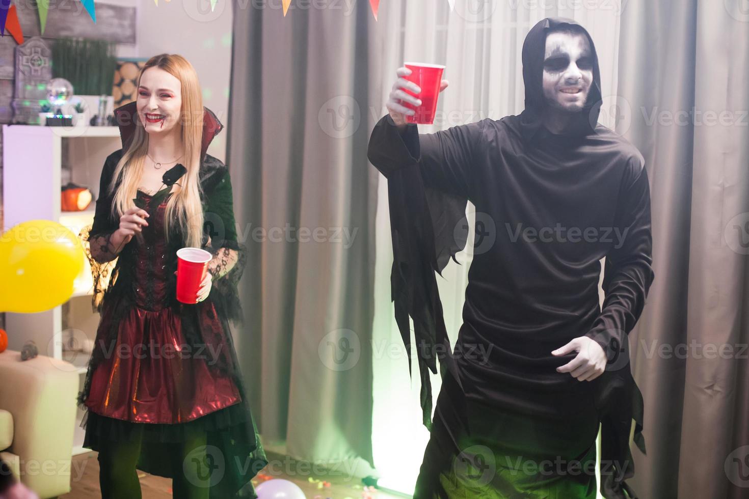 Man dressed up like a spooky grim reaper at a halloween photo