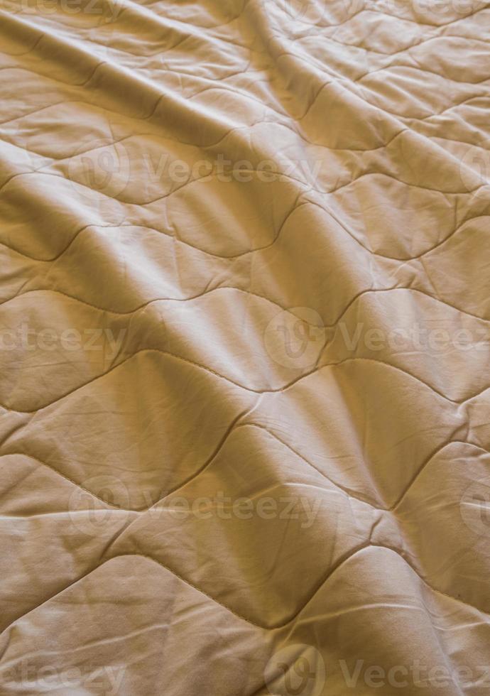 Blanket crumpled on the bed photo