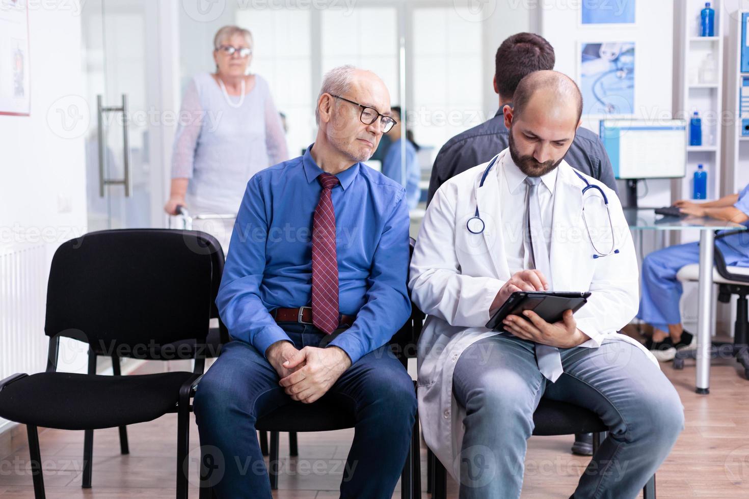 Senior man listening doctor diagnosis photo