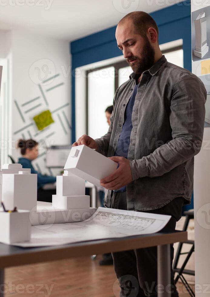 Architecture expert person looking at maquette photo