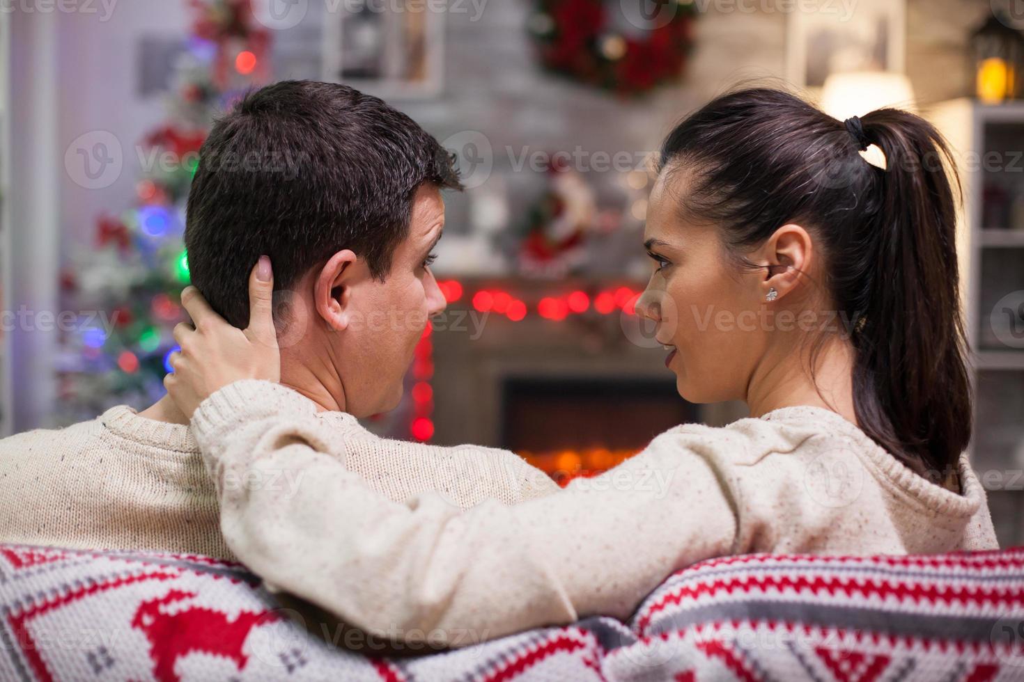 Back view of caucasian couple sitting on couch photo