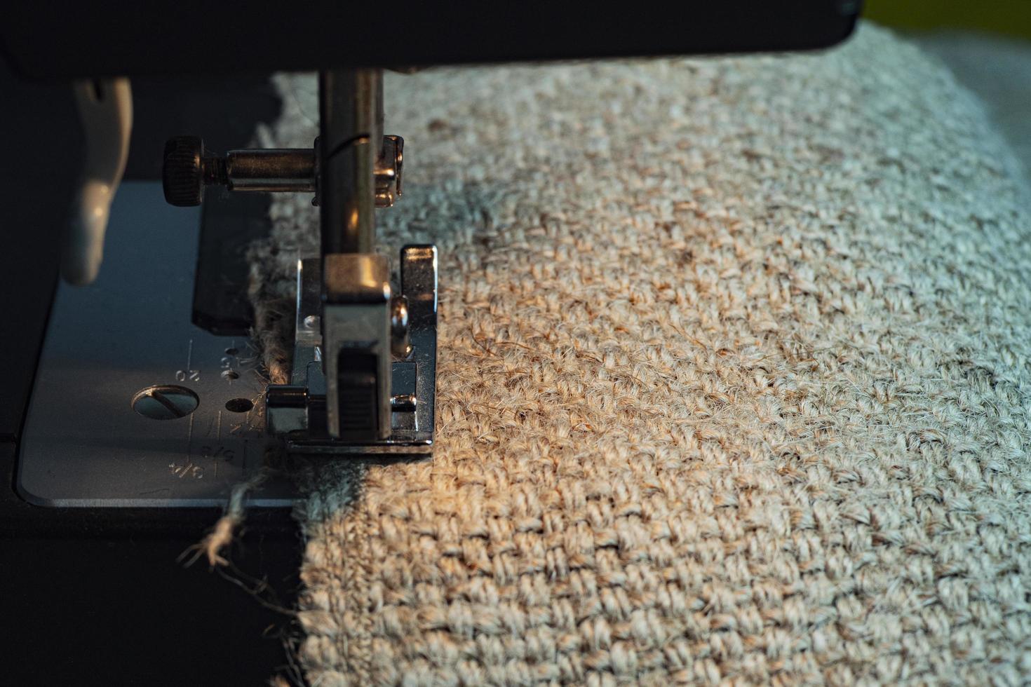A Sewing Machine Sews Burlap Fabric photo