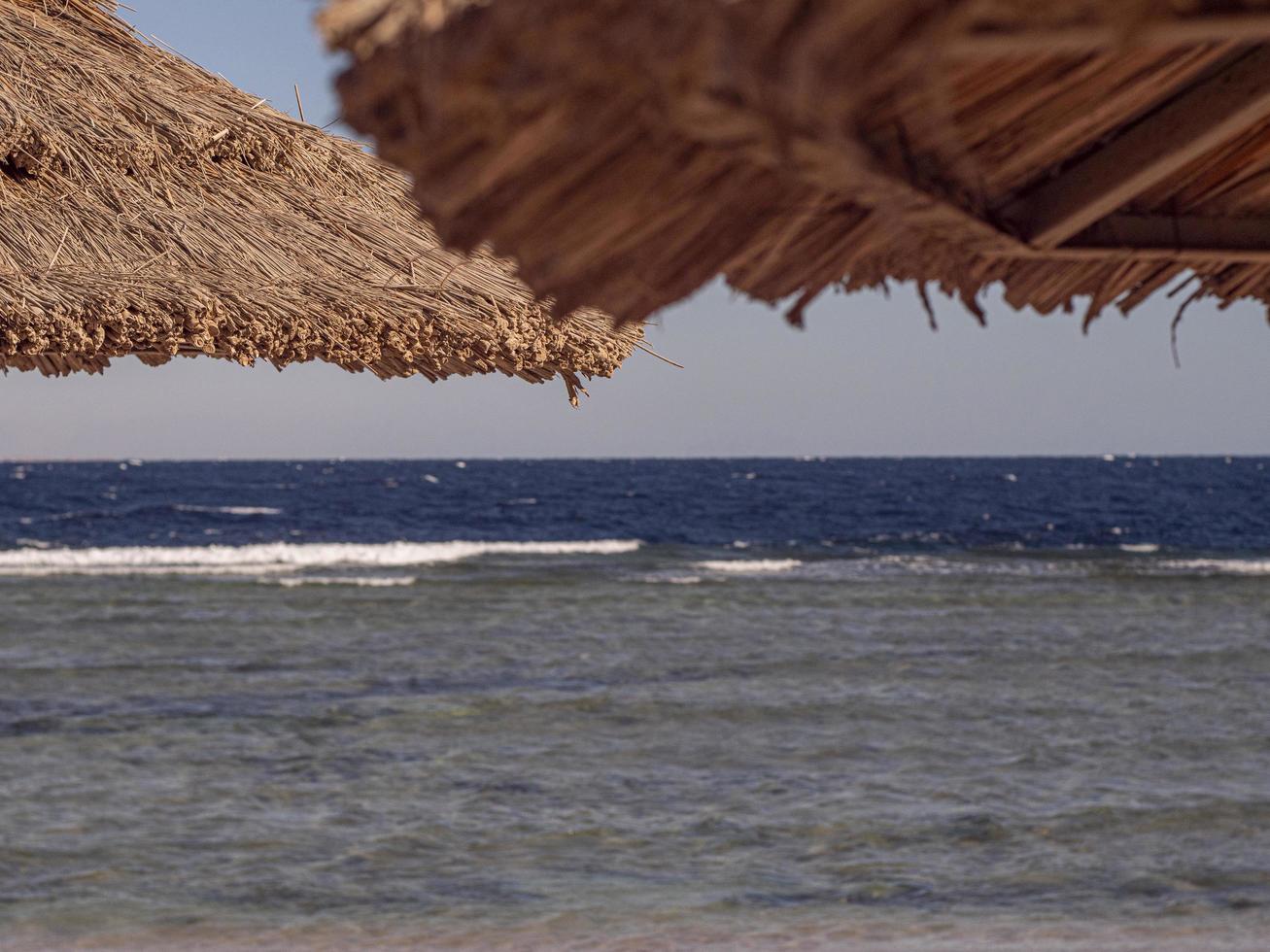 Straw Roof Of Beach Umbrella And Blue Sky photo