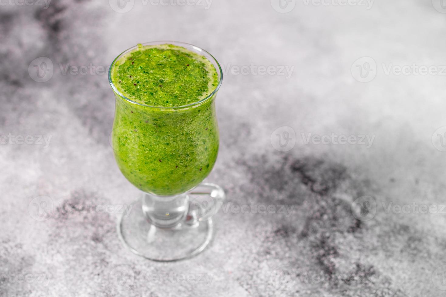 Ginger green apple smoothie on concrete background photo