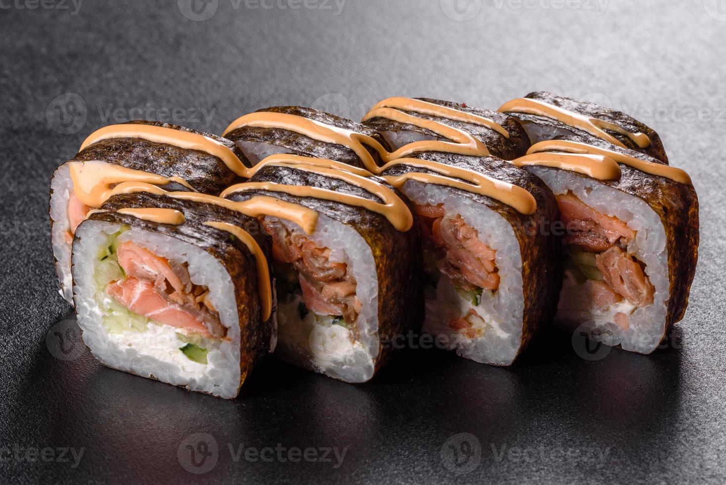 Traditional delicious fresh sushi roll set on a black background photo